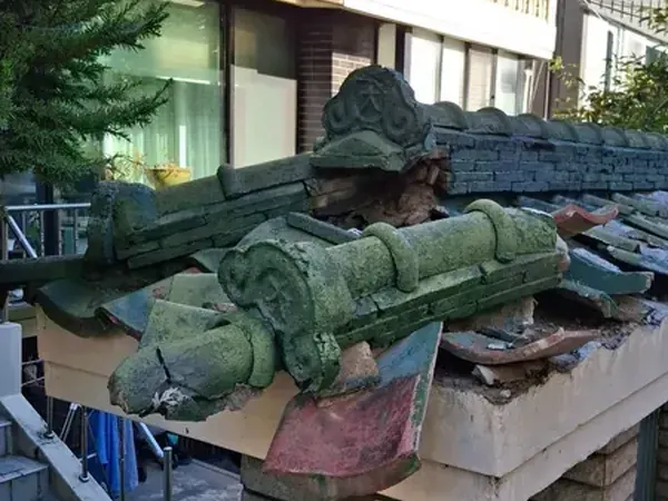 작은 기와지붕 모서리의 추녀마루와 장식기와가 깨지고 주변 기와가 흐트러진 작업 전 상태